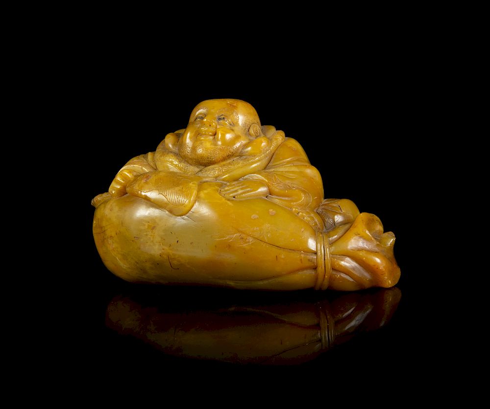 Appraisal: A Carved Soapstone Figure of a Laughing Buddha Length in