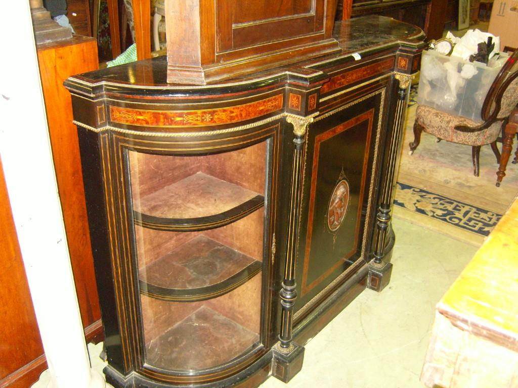 Appraisal: A Victorian ebonised chiffonier enclosed by a central cupboard door