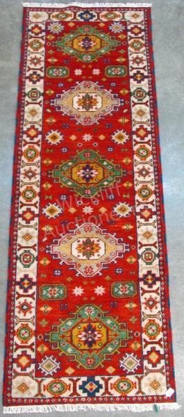 Appraisal: A Handmade Oriental Runner Kazak design red field with green