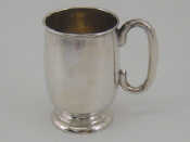 Appraisal: A heavy silver mug the plain body with tucked under