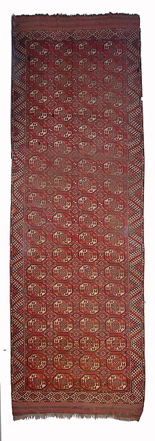 Appraisal: A TURKOMAN KIZIL AYAK BRICK RED GROUND CARPET decorated four