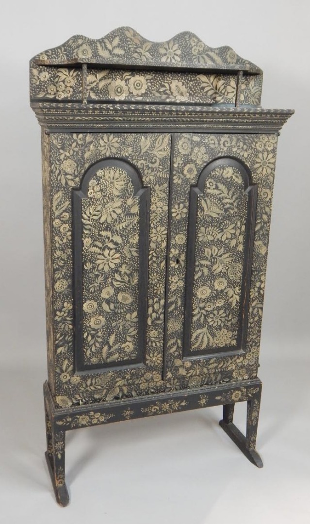 Appraisal: A mid thC ebonised side cabinet painted with flowers leaves