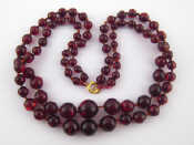 Appraisal: A two row red faux amber bead necklace approx cm