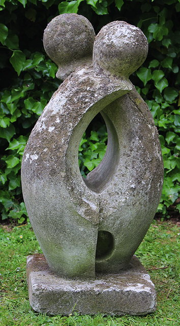 Appraisal: A CARVED STONE ABSTRACT SCULPTURE OF TWO INTERTWINED FIGURES with