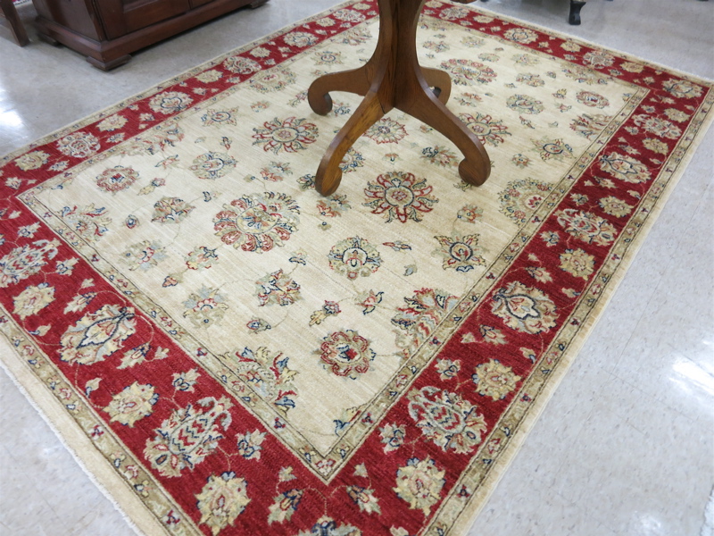 Appraisal: HAND KNOTTED ORIENTAL CARPET Indo-Persian featuring a rectangular khaki field