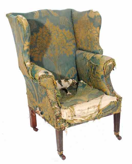 Appraisal: A GEORGIAN STYLE WING BACK ARMCHAIR with remnants of William