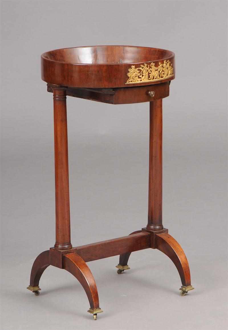 Appraisal: EMPIRE GILT-METAL-MOUNTED MAHOGANY SEWING TABLE The circular tray top above