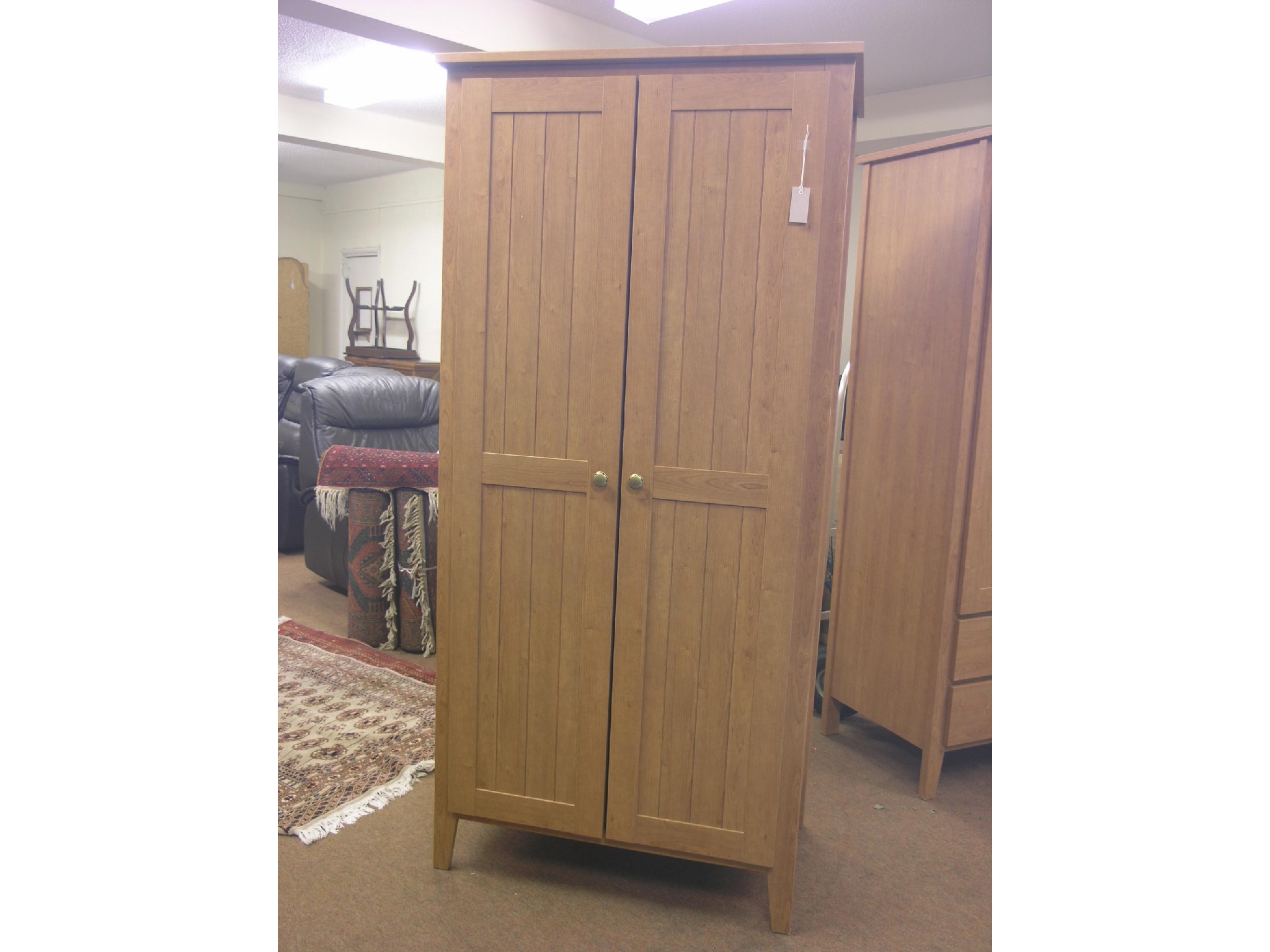 Appraisal: A modern cherry wood wardrobe enclosed by a pair of