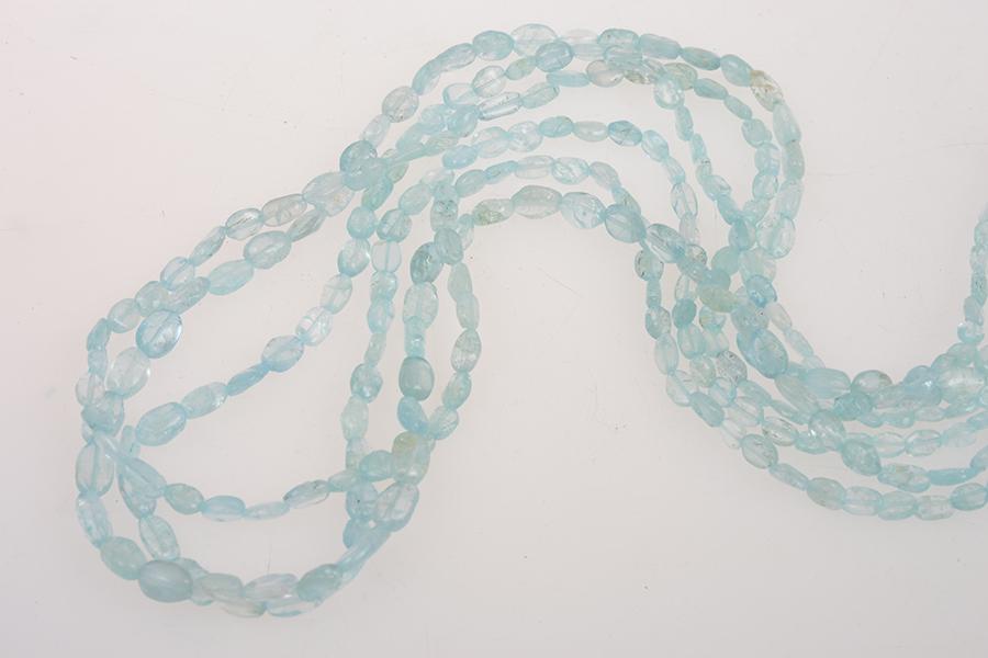 Appraisal: A MULTI-STRAND BEAD NECKLACE IN AQUAMARINE A MULTI-STRAND BEAD NECKLACE