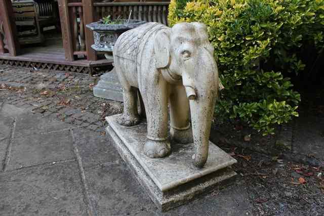 Appraisal: A PAIR OF RECONSTITUTED STONE STANDING ELEPHANTS on rectangular plinth