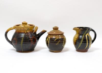 Appraisal: Studio Pottery a three-piece tea service of dark glaze with