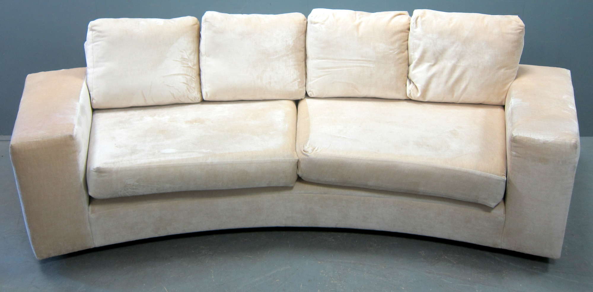 Appraisal: Contemporary curved sofa upholstered in cream chenille cm wide