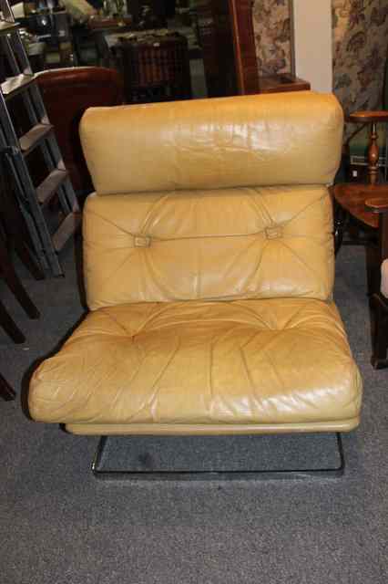 Appraisal: A HEALS s LOUNGER caramel coloured leather and aluminium feet