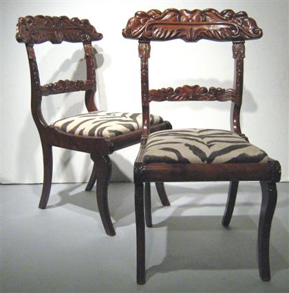 Appraisal: Pair of Colonial carved mahogany side chairs Each with a