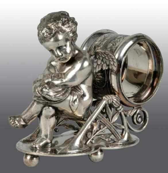 Appraisal: Winged Cherub Sits Cross-Legged Napkin Holder Description By Pairpoint On