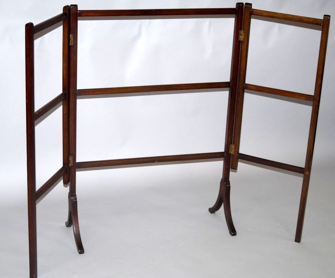 Appraisal: An Edwardian mahogany three fold towel rail raised on splayed