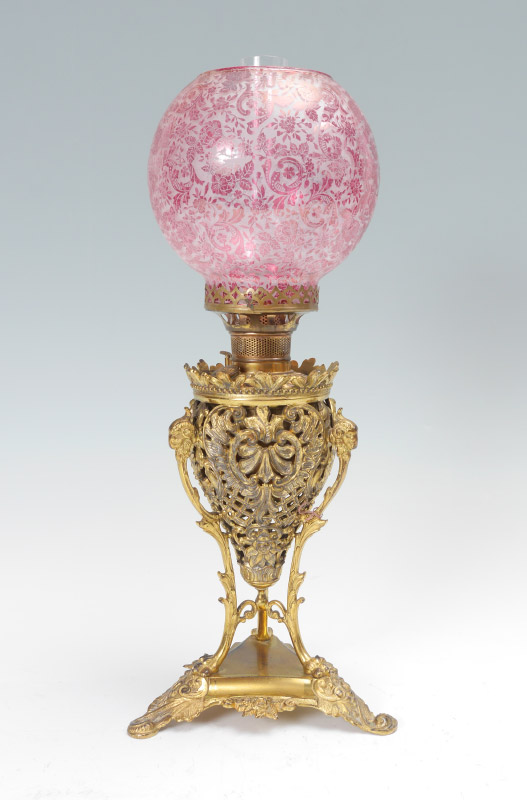 Appraisal: BRADLEY HUBBARD CRANBERRY OIL LAMP Rococo style open work gilt