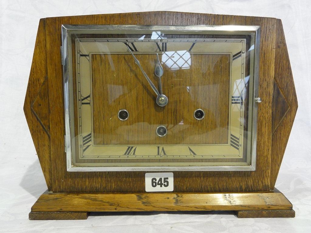 Appraisal: An Art Deco oak three train mantle clock with chrome