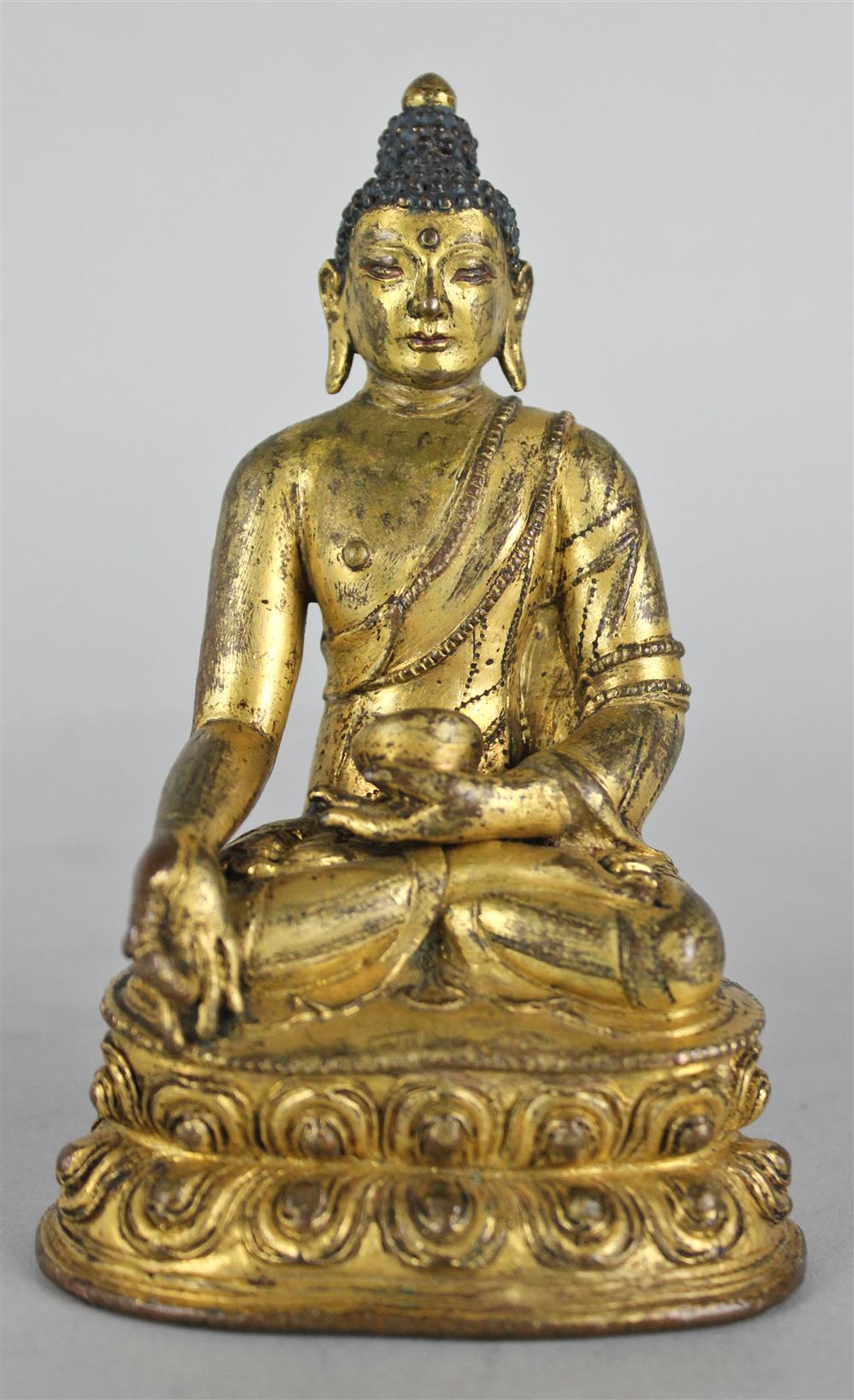 Appraisal: SINO-TIBETAN GILT-BRONZE FIGURE OF THE BUDDHA seated in the lotus