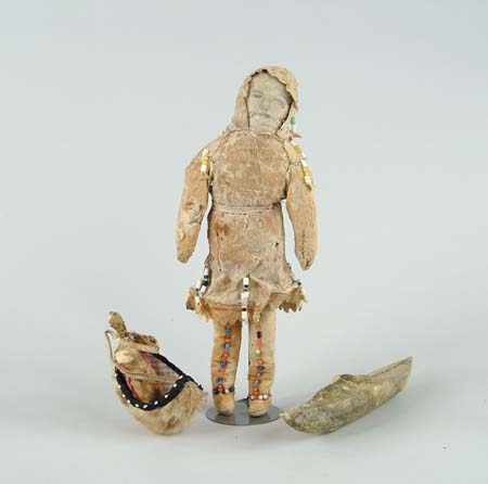 Appraisal: OUTSTANDING EARLY BEAD AND HIDE COVERED ESKIMO DOLL WITH KAYAK