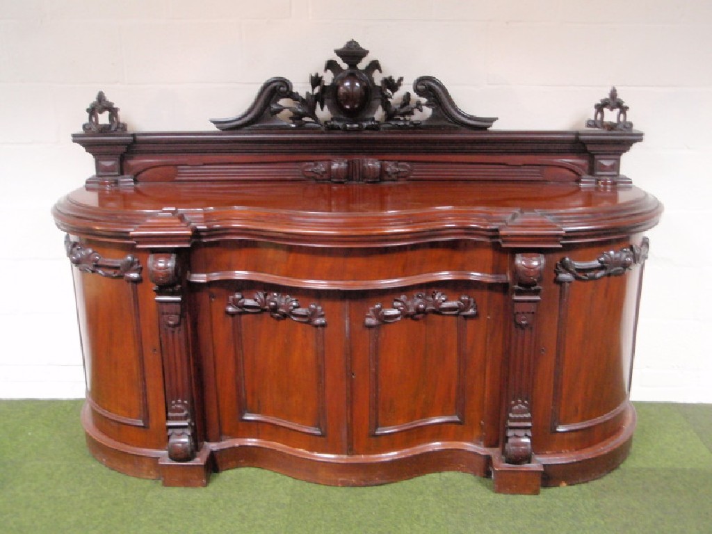 Appraisal: A Victorian figured mahogany sideboard with serpentine front the low