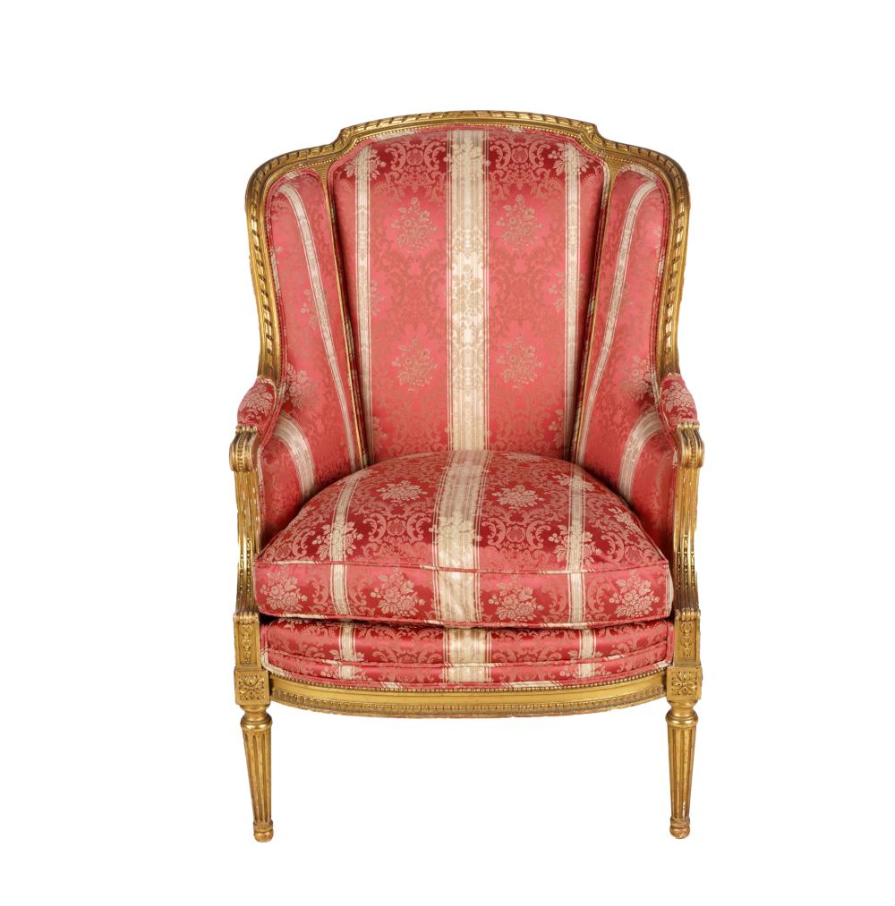 Appraisal: LOUIS XVI-STYLE GILTWOOD BERGEREcovered with striped floral damask inches wide