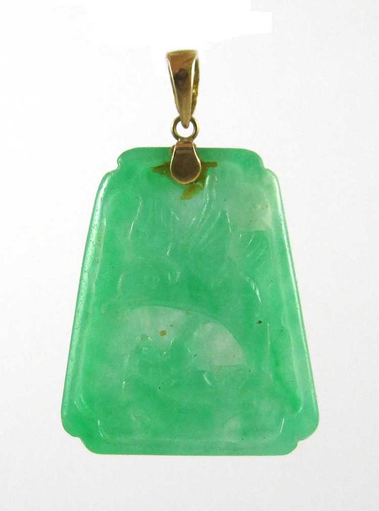 Appraisal: CARVED GREEN JADE PENDANT a trapezoid tablet pendant with pictorial