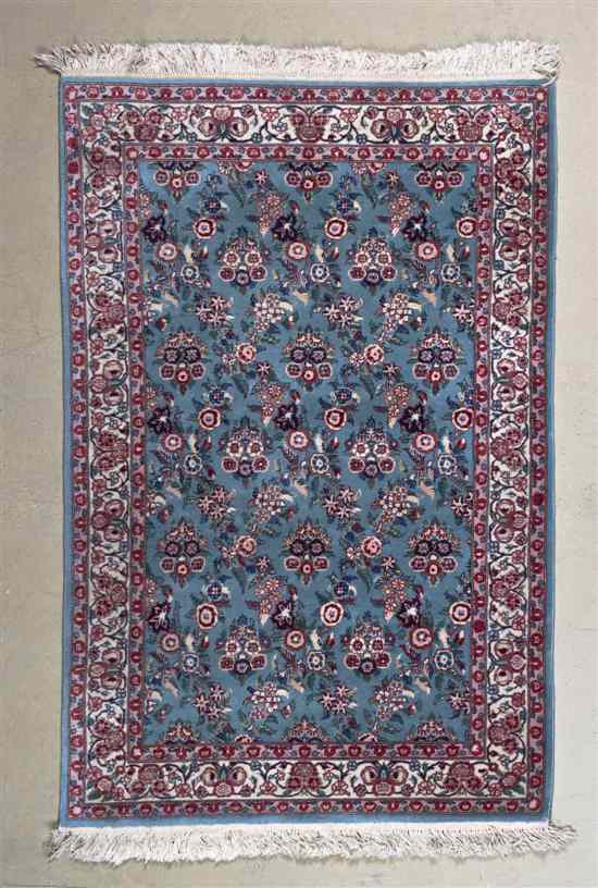 Appraisal: A Persian Wool Rug having repeating floral decoration on a