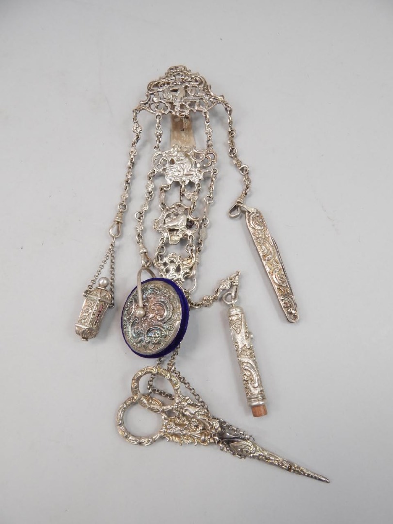 Appraisal: A Victorian silver chatelaine with various chains interspersed with cast