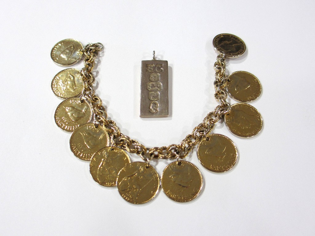 Appraisal: A gilded farthing charm bracelet and a silver ingot