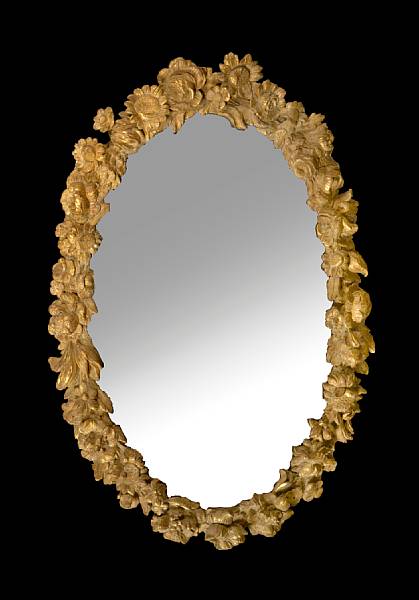 Appraisal: A Continental Rococo carved parcel gilt walnut mirror th century