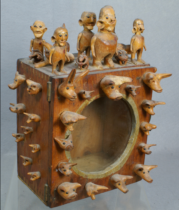 Appraisal: Carved figural folk art cabinet all sides mounted with carved