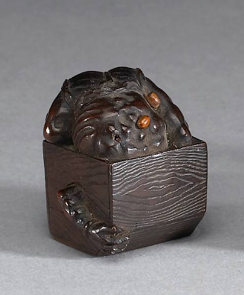 Appraisal: A boxwood netsuke of an oni th Century Partially hidden