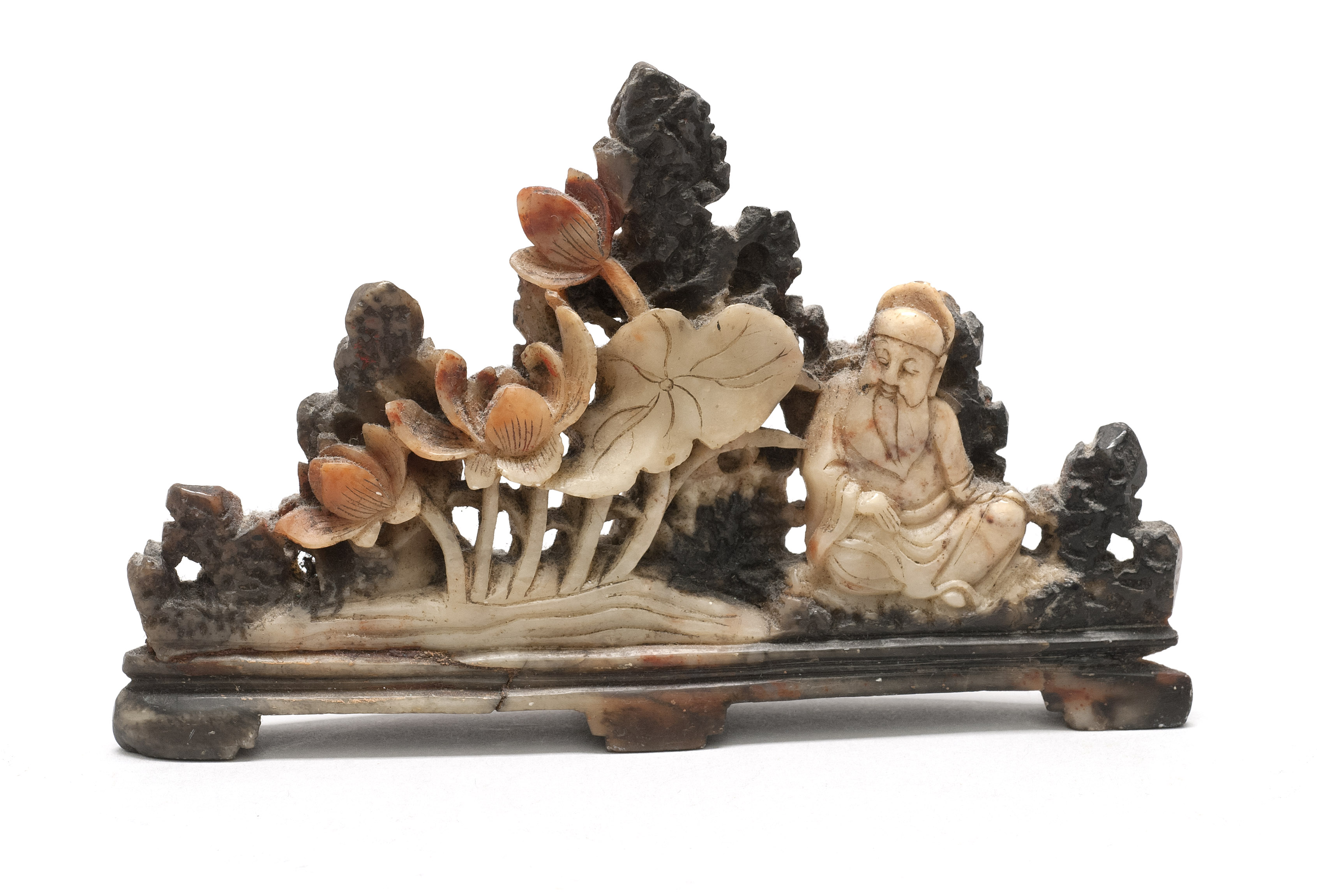 Appraisal: THREE-COLOR SOAPSTONE CARVING th CenturyDepicting a seated sage with lotus