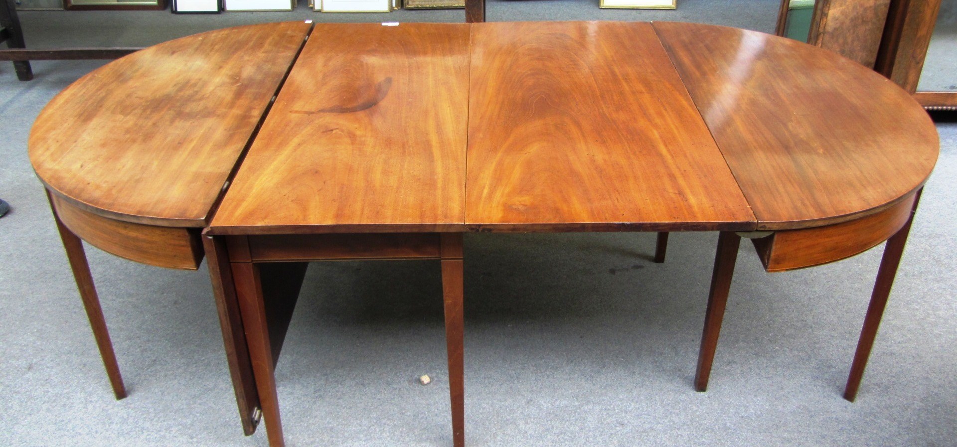 Appraisal: A George III mahogany dining table with pair of 'D'