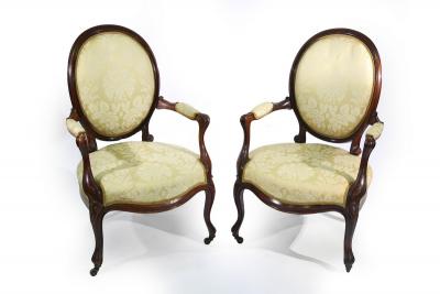 Appraisal: A pair of th Century rosewood framed open armchairs with