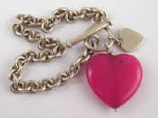 Appraisal: A white metal tests silver bracelet with two pendant heart