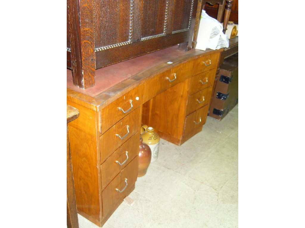 Appraisal: An Art Deco style walnut veneered desk of shaped form