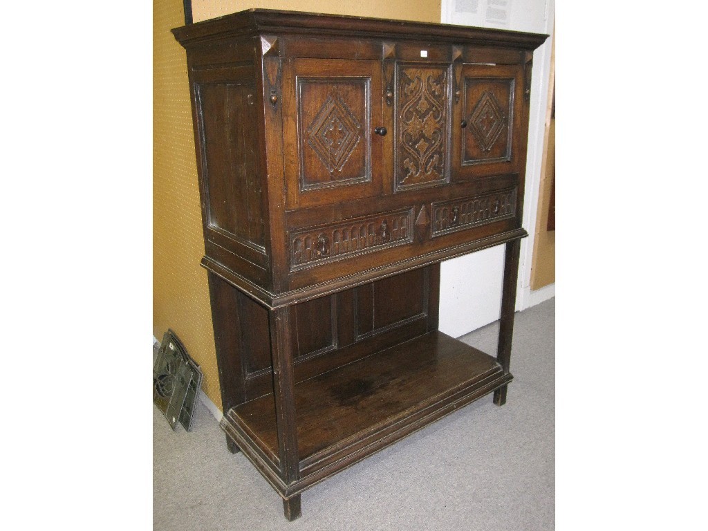 Appraisal: Carved oak cabinet on stand with label for Muirhead Moffat