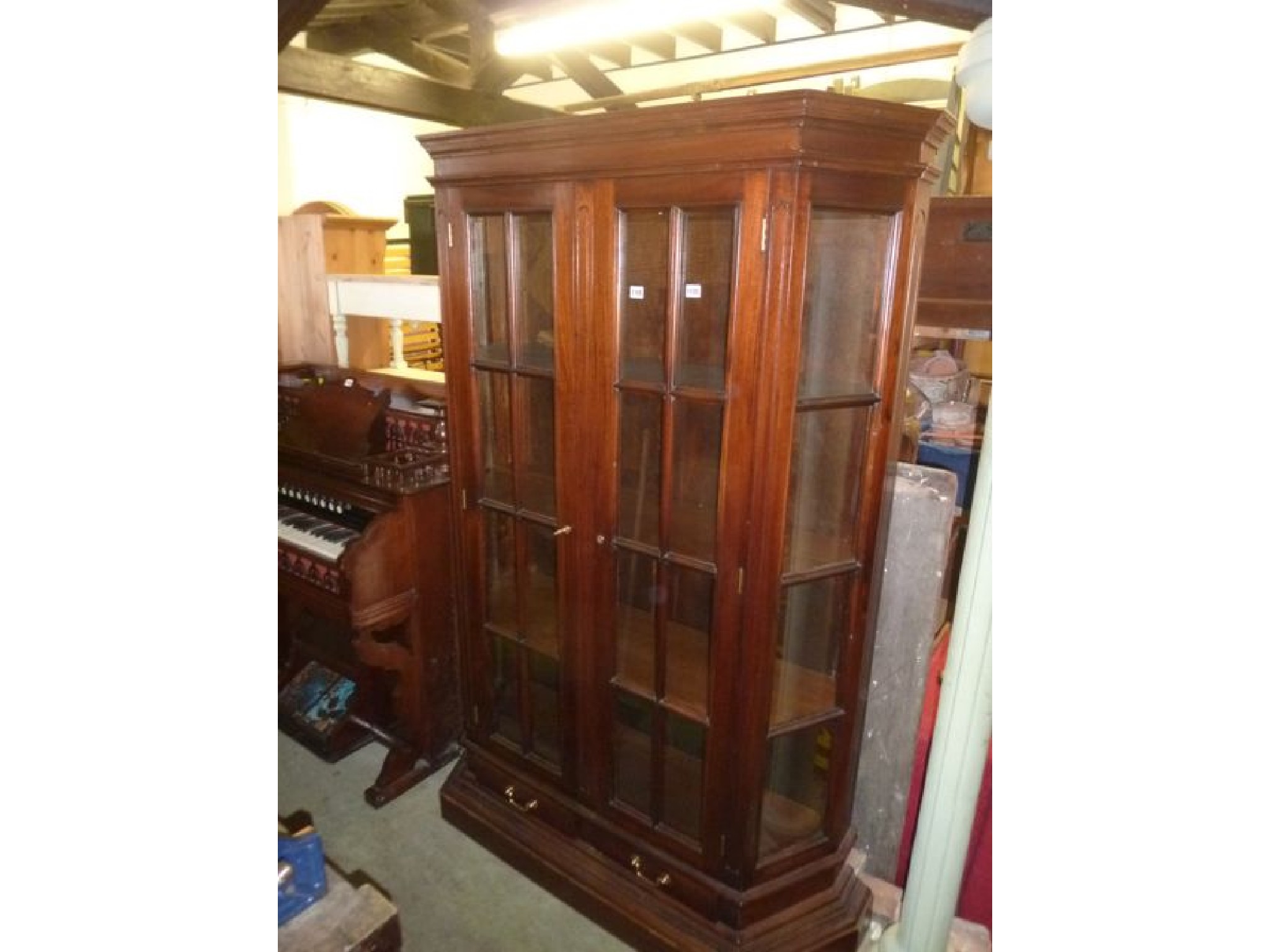 Appraisal: A hardwood freestanding breakfront side cabinet enclosed by a pair