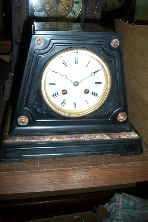 Appraisal: A Victorian black slate and marble clock of geometric tapering