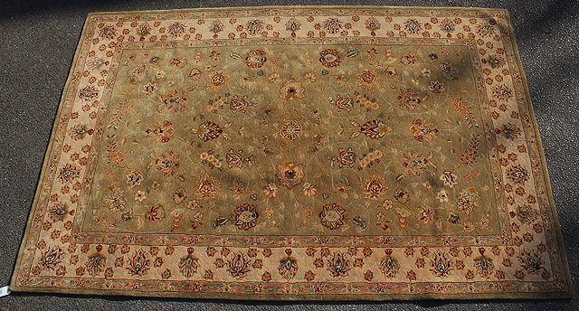 Appraisal: A MODERN GREEN GROUND RUG with decorative foliate design to