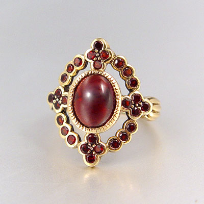 Appraisal: VICTORIAN STYLE GARNET RING K yellow gold ring contains one