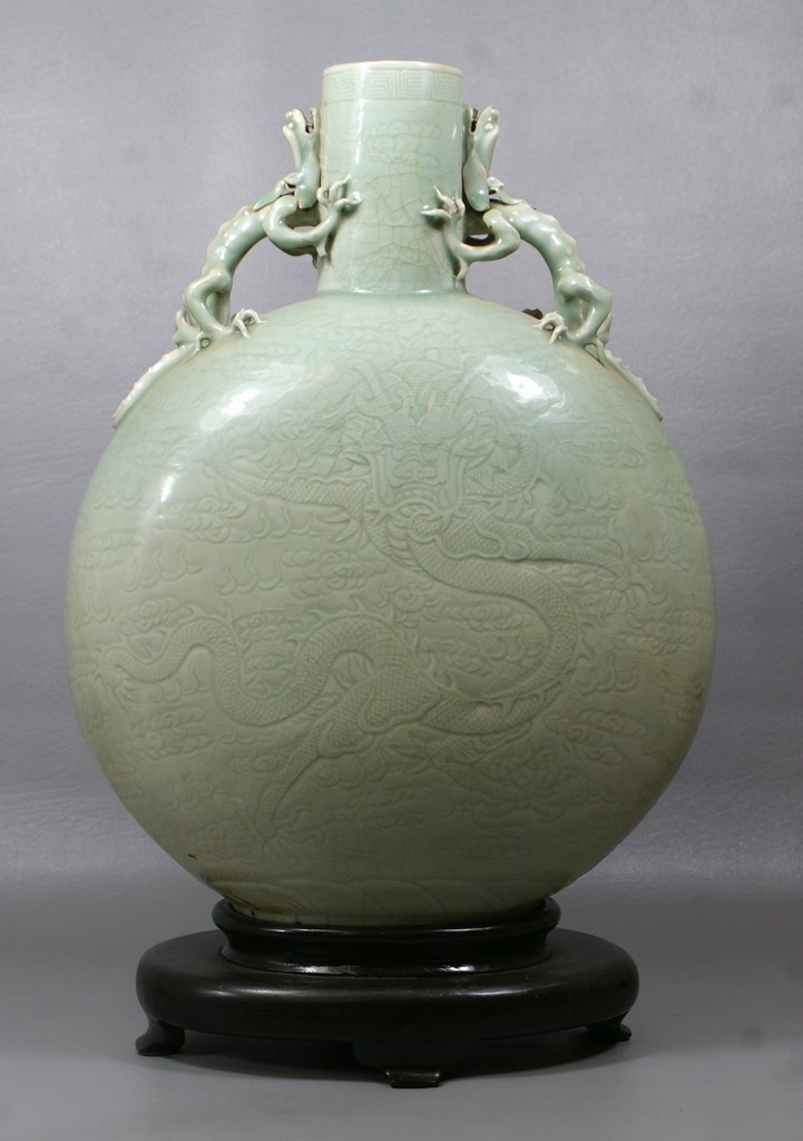 Appraisal: Dragon carved Celadon flattened bottle porcelain vase with applied dragon