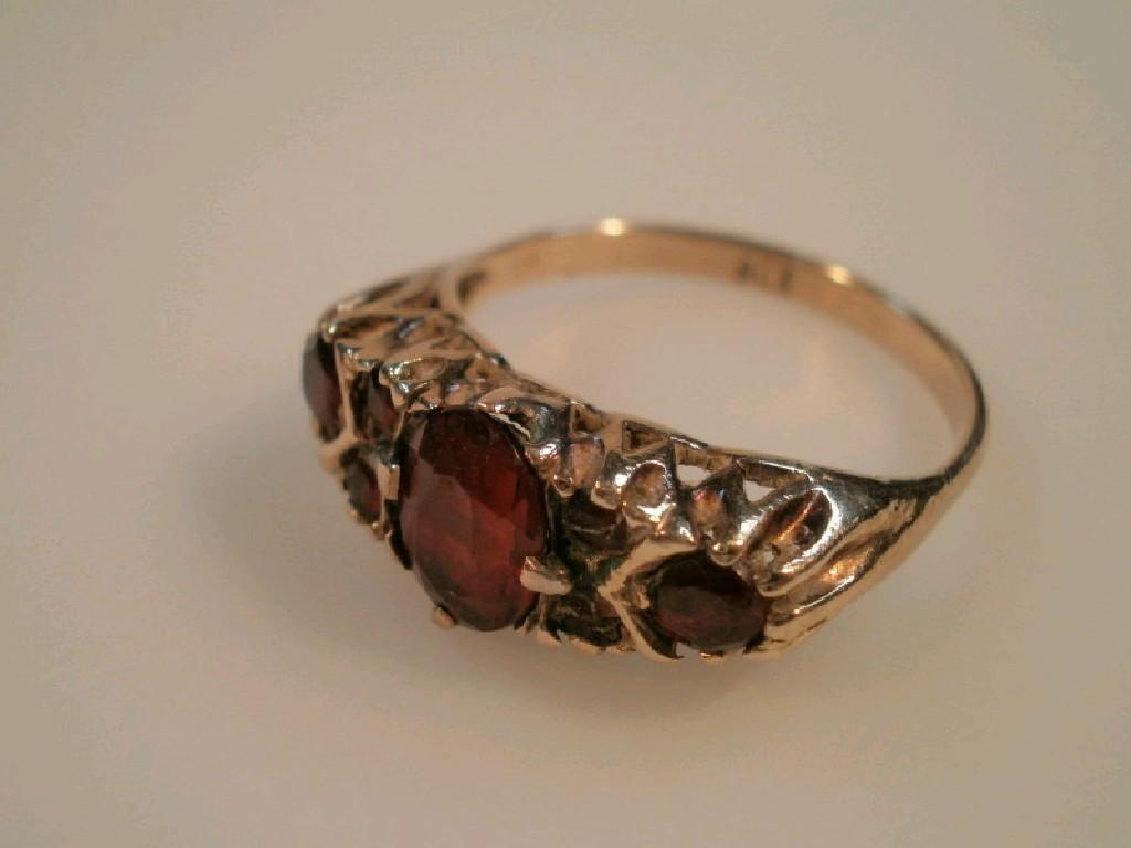 Appraisal: A ct gold half hoop ring set with garnets