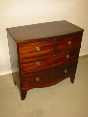 Appraisal: A MAHOGANY CHEST of bowed form with reeded edged top