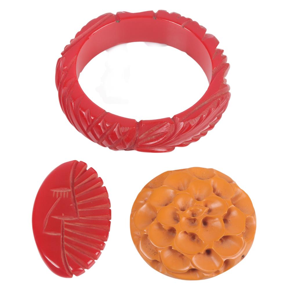 Appraisal: THREE CARVED BAKELITE ITEMS BANGLE PIN AND CLIP W X