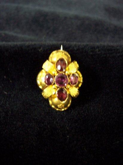 Appraisal: An amethyst brooch mounted in a quatrefoil cushion shaped setting