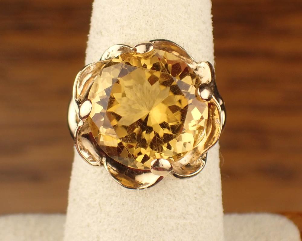 Appraisal: CITRINE AND FOURTEEN KARAT GOLD SOLITAIRE RING with four yellow