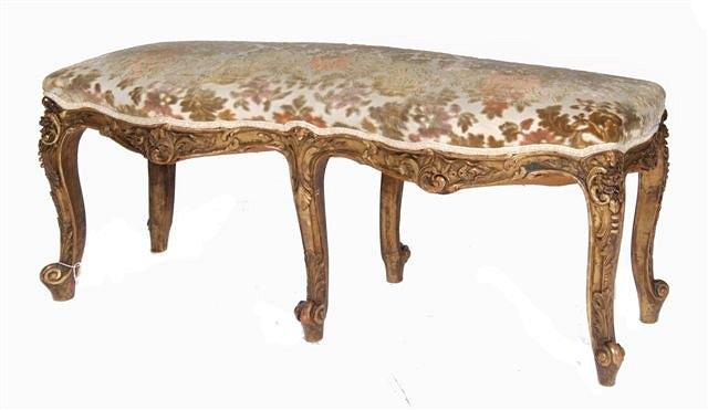 Appraisal: A LOUIS XV STYLE GILTWOOD WINDOW SEAT with carved foliate